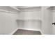Walk-in closet featuring neutral carpet, white walls and shelving at 8379 Drop Camp St, Las Vegas, NV 89123