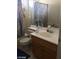 Shot of bathroom with toilet, vanity, mirror, and shower curtain at 8769 Country View Ave, Las Vegas, NV 89129