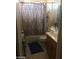 View of a bathroom with a vanity, toilet, and shower with a decorative curtain at 8769 Country View Ave, Las Vegas, NV 89129