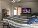 Bedroom with a large bed, tv, and sliding glass door at 8769 Country View Ave, Las Vegas, NV 89129