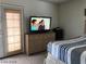 Bedroom with dresser, TV and striped bedding at 8769 Country View Ave, Las Vegas, NV 89129