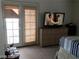 Cozy bedroom featuring a television on a dresser and natural light from the French doors at 8769 Country View Ave, Las Vegas, NV 89129