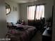 Modest bedroom with neutral walls, window, dark curtains and bed at 8769 Country View Ave, Las Vegas, NV 89129