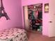Eiffel Tower-themed bedroom with organized closet and open door at 8769 Country View Ave, Las Vegas, NV 89129