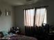 Modest bedroom with neutral walls, window, dark curtains and bed at 8769 Country View Ave, Las Vegas, NV 89129