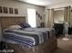 Bedroom featuring a large bed, natural light, and eclectic decor at 8769 Country View Ave, Las Vegas, NV 89129