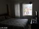 Bedroom with a window overlooking the neighborhood at 8769 Country View Ave, Las Vegas, NV 89129