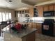 Spacious kitchen with wooden cabinets, granite countertops, and modern black appliances at 8769 Country View Ave, Las Vegas, NV 89129