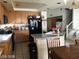 Functional kitchen featuring wooden cabinets, granite countertops, and modern black appliances at 8769 Country View Ave, Las Vegas, NV 89129