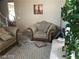 Inviting living room area with neutral tones, a comfortable armchair, and plenty of natural light at 8769 Country View Ave, Las Vegas, NV 89129