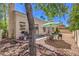 Picturesque backyard featuring a patio, gravel, mature trees, and outdoor seating area at 8800 Crescent Ridge Ln, Las Vegas, NV 89134