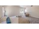 Bright bedroom featuring plush carpet, a cozy armchair, and a large window at 8800 Crescent Ridge Ln, Las Vegas, NV 89134