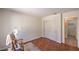 Cozy bedroom featuring hardwood floors, natural light, and sliding closet doors at 8800 Crescent Ridge Ln, Las Vegas, NV 89134