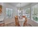 Charming breakfast nook featuring bright windows, and quaint wooden chairs at 8800 Crescent Ridge Ln, Las Vegas, NV 89134