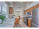 Bright kitchen with natural wood cabinetry, sleek appliances, and adjacent breakfast nook at 8800 Crescent Ridge Ln, Las Vegas, NV 89134