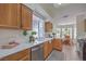 Well-lit kitchen with wooden cabinets, stainless steel appliances, and a view to the breakfast nook at 8800 Crescent Ridge Ln, Las Vegas, NV 89134