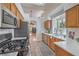 Functional kitchen featuring modern appliances, natural wood cabinets, and tiled flooring at 8800 Crescent Ridge Ln, Las Vegas, NV 89134