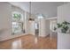 Spacious living room with light hardwood floors, vaulted ceilings, and large windows at 8800 Crescent Ridge Ln, Las Vegas, NV 89134