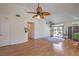 A spacious living room featuring hardwood floors, plants, and access to the backyard at 8800 Crescent Ridge Ln, Las Vegas, NV 89134