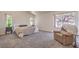 Serene primary bedroom featuring carpeted floors, a comfortable recliner, and natural lighting at 8800 Crescent Ridge Ln, Las Vegas, NV 89134