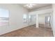 A bedroom with neutral carpet, ceiling fan, and a wall with mirrored closet doors at 8805 Jeffreys St # 1003, Las Vegas, NV 89123