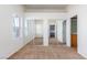A bedroom with neutral carpet, two windows, and a wall with mirrored closet doors at 8805 Jeffreys St # 1003, Las Vegas, NV 89123