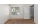 A bedroom with neutral carpet, white walls, a window, and an open door at 8805 Jeffreys St # 1003, Las Vegas, NV 89123