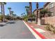 View of the Pebble Creek Village community sign surrounded by palm trees and landscaping at 8805 Jeffreys St # 1003, Las Vegas, NV 89123