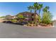 Exterior view of building with lush landscaping, covered parking, and palm trees on a sunny day at 8805 Jeffreys St # 1003, Las Vegas, NV 89123