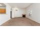 Open concept living room with fireplace, large windows, and neutral carpet at 8805 Jeffreys St # 1003, Las Vegas, NV 89123