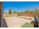 Spacious backyard with an oversized paver patio, a low brick wall, and a section of manicured artificial grass at 920 Cirrus Cloud Ave, Las Vegas, NV 89138