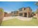 Private backyard showcases a spacious paver patio, synthetic turf, and a contemporary outdoor seating area at 920 Cirrus Cloud Ave, Las Vegas, NV 89138