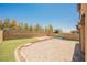 Expansive backyard featuring a large paver patio, a built-in stone seating area, and artificial grass at 920 Cirrus Cloud Ave, Las Vegas, NV 89138