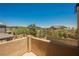 Exterior balcony view of landscaped backyards and community homes beyond a tan stucco wall at 920 Cirrus Cloud Ave, Las Vegas, NV 89138