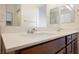 Bathroom with double sinks and wood cabinets at 920 Cirrus Cloud Ave, Las Vegas, NV 89138