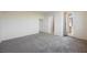 Bright bedroom with neutral paint, carpet, and an ensuite bathroom at 920 Cirrus Cloud Ave, Las Vegas, NV 89138