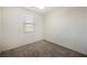 Bright bedroom with gray carpeting, a ceiling fan and a window offering plenty of natural light at 920 Cirrus Cloud Ave, Las Vegas, NV 89138