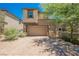 Lovely two-story home with a two-car garage, manicured landscaping, and a lush shade tree at 920 Cirrus Cloud Ave, Las Vegas, NV 89138