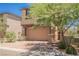 Beautiful two-story home featuring a two-car garage, meticulous landscaping, and mature shade trees at 920 Cirrus Cloud Ave, Las Vegas, NV 89138