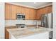Well-equipped kitchen with stainless steel appliances, granite countertops, and ample wood cabinet space at 920 Cirrus Cloud Ave, Las Vegas, NV 89138