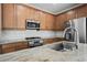 Close-up of a well-equipped kitchen with stainless steel appliances and granite countertops at 920 Cirrus Cloud Ave, Las Vegas, NV 89138