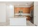 Modern kitchen with a large island, stainless steel appliances, granite countertops, and wood cabinets at 920 Cirrus Cloud Ave, Las Vegas, NV 89138
