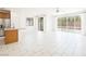 Bright living room with white tile floors, recessed lighting, and sliding glass doors to the backyard at 920 Cirrus Cloud Ave, Las Vegas, NV 89138