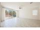 Bright, open living area featuring tile flooring, large sliding glass doors to the backyard, and a ceiling fan at 920 Cirrus Cloud Ave, Las Vegas, NV 89138