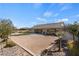 This private backyard features desert landscaping, palm trees and partial grass at 9240 Northfield Park Ct, Las Vegas, NV 89148
