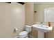 Powder room featuring a pedestal sink, mirror and a toilet at 9240 Northfield Park Ct, Las Vegas, NV 89148