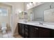 Bathroom with double vanity, dark cabinets, and a large mirror creates a bright, modern space at 9240 Northfield Park Ct, Las Vegas, NV 89148