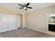 Neutral bedroom featuring a ceiling fan, a closet and plush carpet floors at 9240 Northfield Park Ct, Las Vegas, NV 89148
