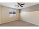 Neutral bedroom featuring a ceiling fan, a large window and plush carpet floors at 9240 Northfield Park Ct, Las Vegas, NV 89148
