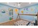 Themed bedroom with ocean-inspired murals, ceiling fan and carpeted floors at 9240 Northfield Park Ct, Las Vegas, NV 89148